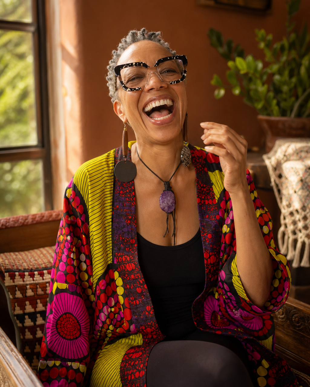 Bernadette laughing in a colorful African-print kimono